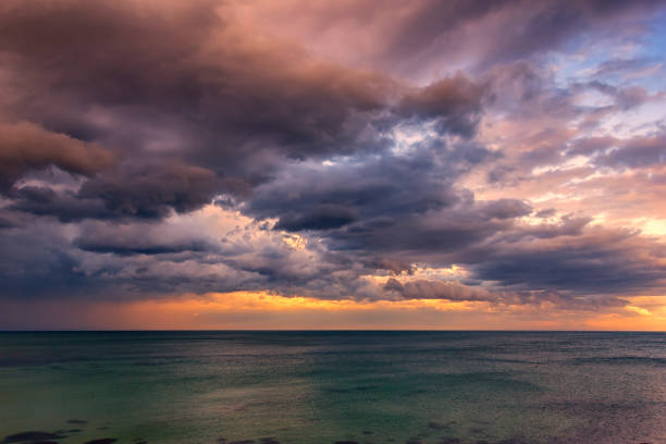 Exciting sunset. Beautiful colorful clouds over the sea.